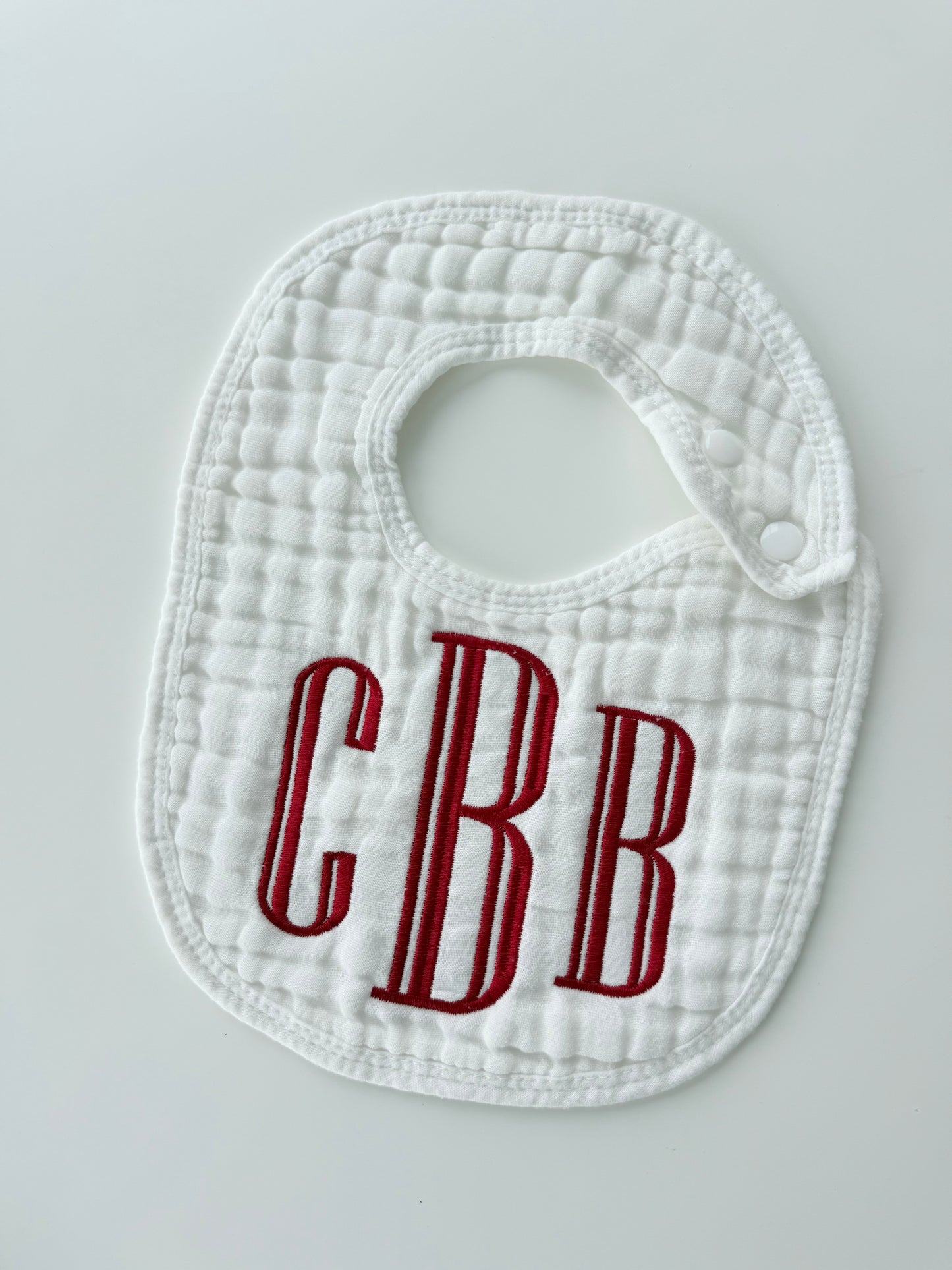 Monogram Muslin Baby Bib